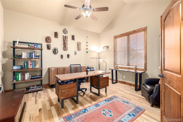 office featuring ceiling fan, light wood-type flooring, and vaulted ceiling