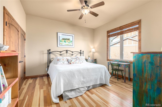 bedroom with light hardwood / wood-style flooring and ceiling fan