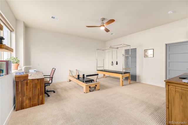 home office featuring ceiling fan and light carpet