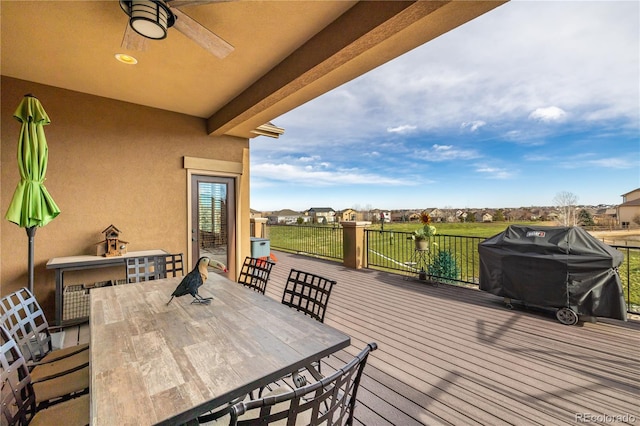 wooden terrace featuring a grill and ceiling fan