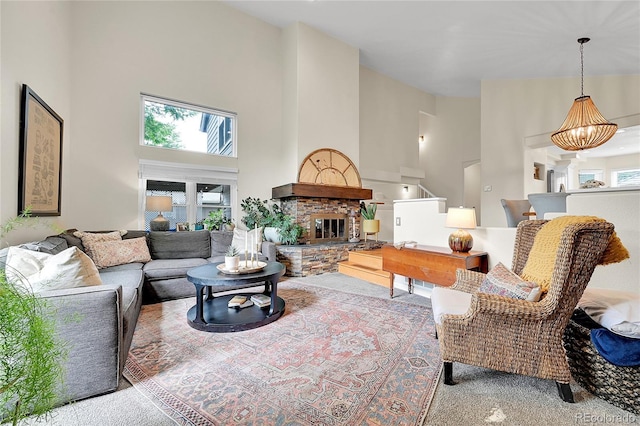 carpeted living area featuring high vaulted ceiling and a fireplace