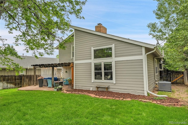 rear view of property featuring a pergola, a patio area, a chimney, cooling unit, and an outdoor hangout area