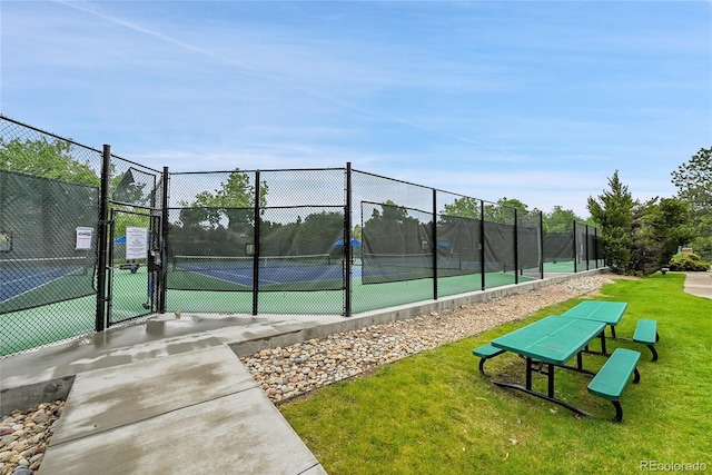 view of tennis court featuring a gate