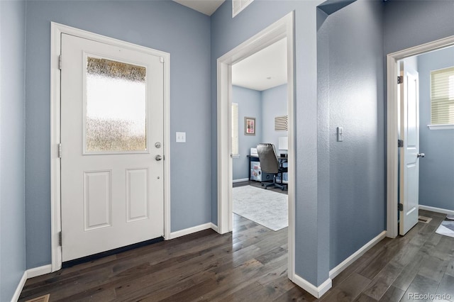 entrance foyer featuring dark wood finished floors and baseboards