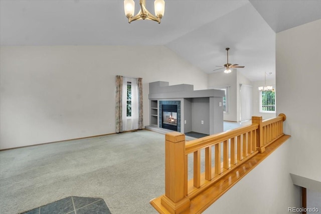 5960 S Estes St, Littleton, CO 80123 - unfurnished living room with a chandelier, vaulted ceiling, a fireplace, carpet, and ceiling fan