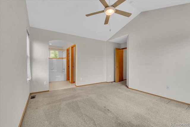 5960 S Estes St, Littleton, CO 80123 - carpeted empty room featuring arched walkways, ceiling fan, vaulted ceiling, and baseboards