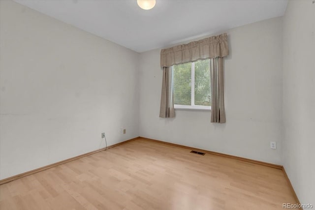 5960 S Estes St, Littleton, CO 80123 - unfurnished room featuring wood finished floors and baseboards