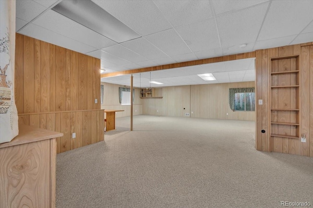 5960 S Estes St, Littleton, CO 80123 - basement with wooden walls, carpet floors, and a paneled ceiling