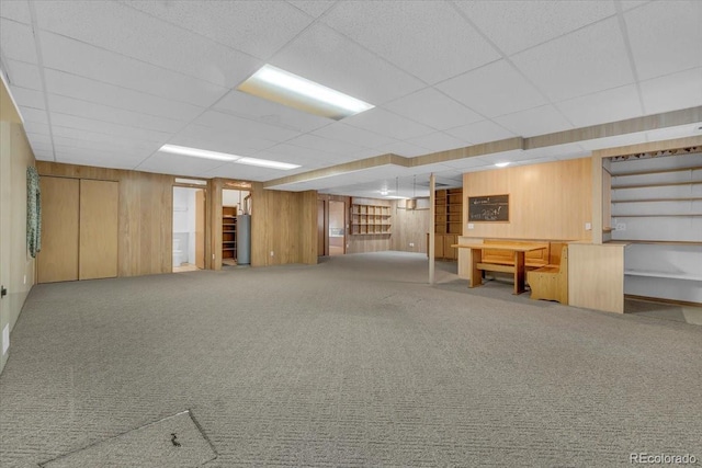 5960 S Estes St, Littleton, CO 80123 - finished basement with wood walls, carpet floors, stairway, and a paneled ceiling