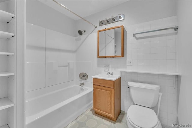 5960 S Estes St, Littleton, CO 80123 - full bathroom with tile walls, bathing tub / shower combination, toilet, and vanity