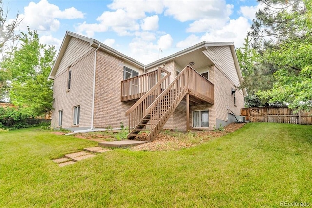 5960 S Estes St, Littleton, CO 80123 - rear view of house with a wooden deck, stairway, and brick siding