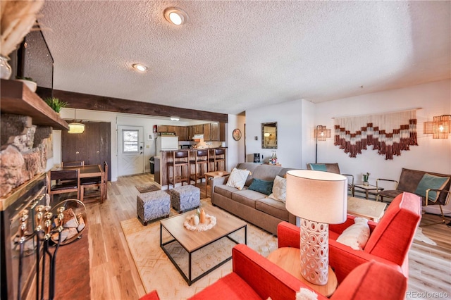 living room with light hardwood / wood-style flooring and a textured ceiling