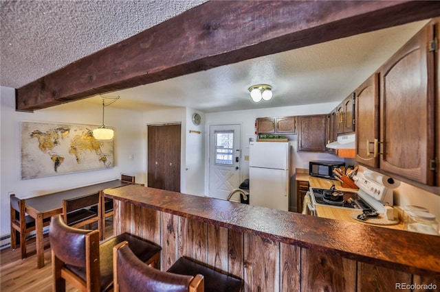 kitchen with exhaust hood, light wood-type flooring, pendant lighting, sink, and white appliances