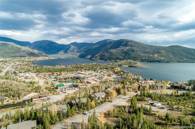 drone / aerial view with a water and mountain view