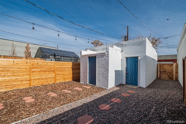 view of outbuilding featuring an outdoor structure and a fenced backyard