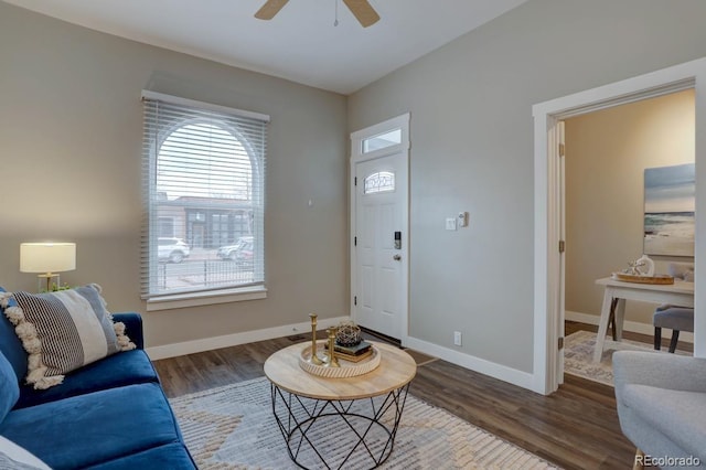 living area featuring ceiling fan, wood finished floors, and baseboards