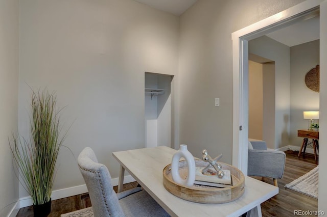 dining room featuring dark wood-style floors and baseboards