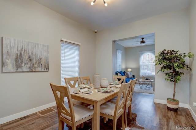 dining room with visible vents, baseboards, and wood finished floors