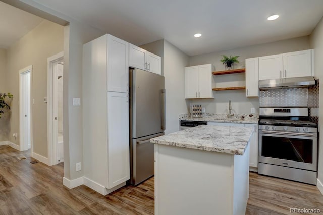 kitchen with open shelves, stainless steel appliances, white cabinets, a sink, and under cabinet range hood