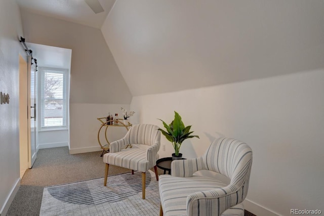 living area featuring vaulted ceiling, carpet floors, and baseboards