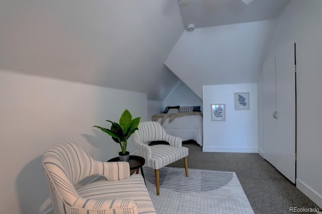 sitting room with lofted ceiling, carpet flooring, and baseboards