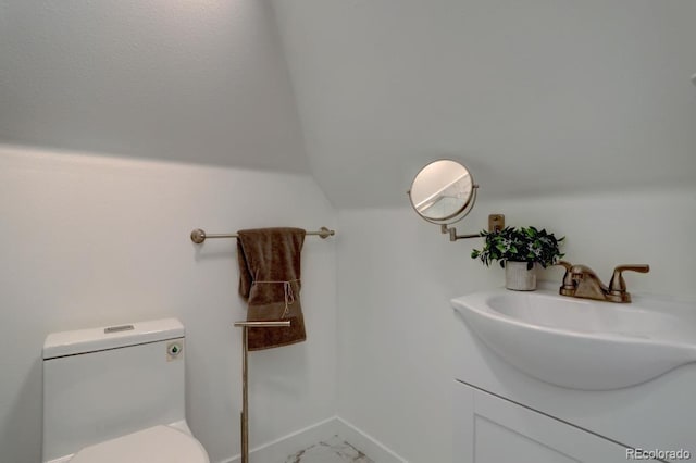 half bath with marble finish floor, toilet, vaulted ceiling, vanity, and baseboards