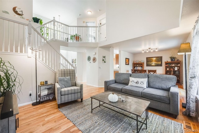 living room featuring hardwood / wood-style floors and a towering ceiling