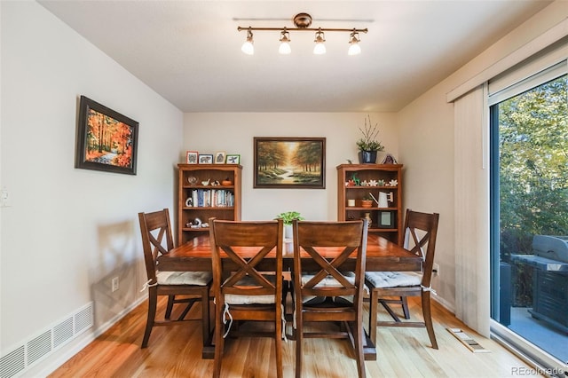 dining room with hardwood / wood-style flooring