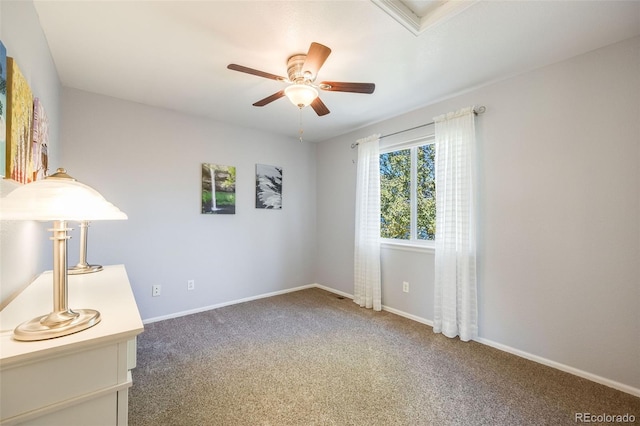 unfurnished room featuring dark colored carpet and ceiling fan