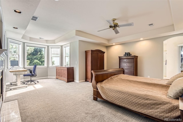 7866 Witney Pl, Lone Tree, CO 80124 - bedroom featuring a tray ceiling, light carpet, arched walkways, recessed lighting, and an office area