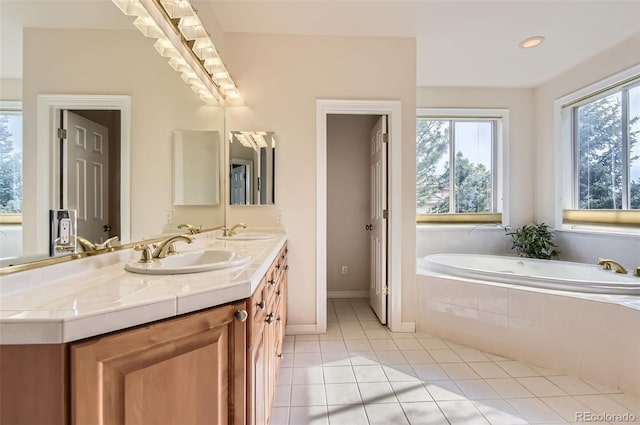 7866 Witney Pl, Lone Tree, CO 80124 - full bathroom featuring double vanity, healthy amount of natural light, a bath, tile patterned floors, and recessed lighting
