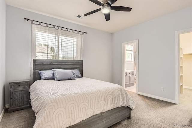 7866 Witney Pl, Lone Tree, CO 80124 - carpeted bedroom with multiple windows, a walk in closet, connected bathroom, and a ceiling fan