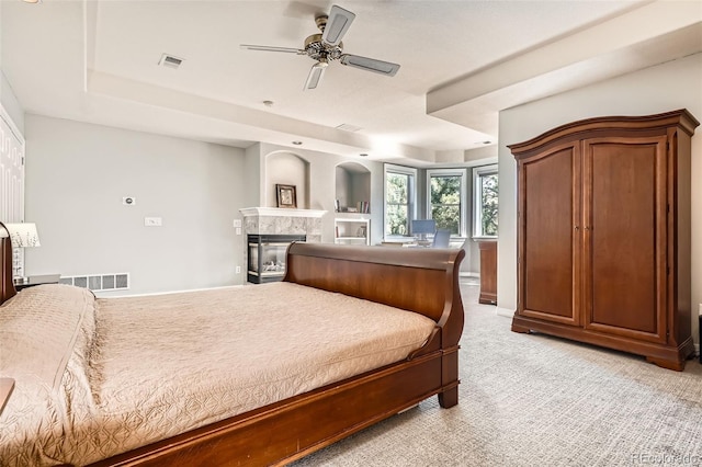 7866 Witney Pl, Lone Tree, CO 80124 - bedroom with a high end fireplace, light colored carpet, and a ceiling fan