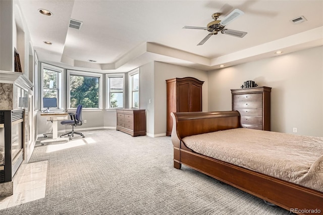 7866 Witney Pl, Lone Tree, CO 80124 - bedroom featuring carpet flooring, a raised ceiling, a desk, recessed lighting, and a tile fireplace