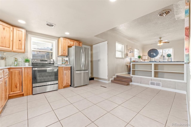 kitchen featuring stainless steel appliances, a textured ceiling, ceiling fan, and light tile patterned floors