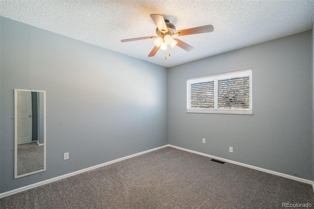 carpeted empty room with a textured ceiling and ceiling fan