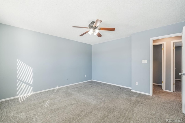 carpeted spare room featuring ceiling fan and a textured ceiling