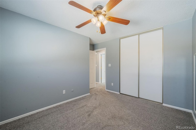 unfurnished bedroom featuring ceiling fan, a closet, carpet, and a textured ceiling