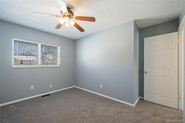 unfurnished room with a textured ceiling, carpet floors, and ceiling fan