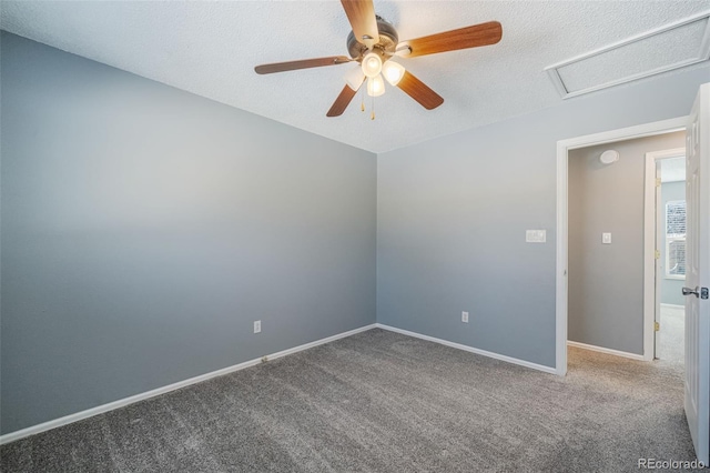 carpeted empty room with ceiling fan and a textured ceiling