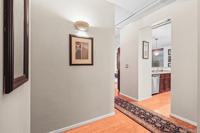 444 17th St Unit 603, Denver, CO 80202 - hallway featuring baseboards and light wood-style floors