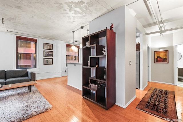 444 17th St Unit 603, Denver, CO 80202 - living room featuring baseboards and light wood finished floors