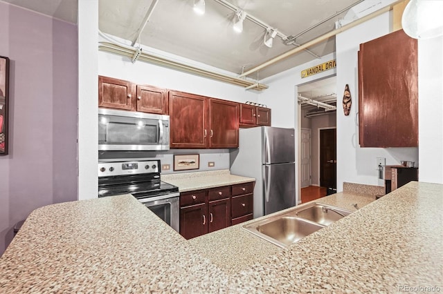 444 17th St Unit 603, Denver, CO 80202 - kitchen featuring a sink, track lighting, and appliances with stainless steel finishes