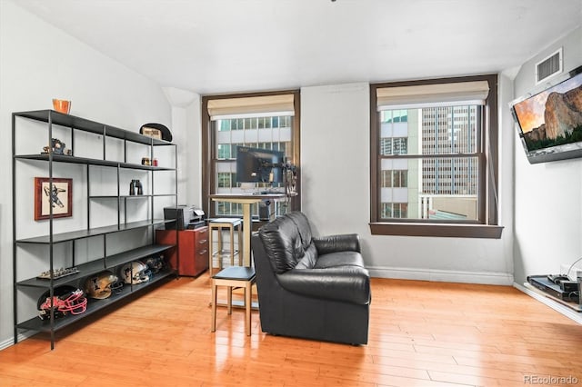444 17th St Unit 603, Denver, CO 80202 - sitting room featuring wood finished floors, a wealth of natural light, baseboards, and visible vents