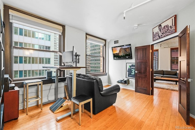 444 17th St Unit 603, Denver, CO 80202 - living room with baseboards, light wood finished floors, and visible vents