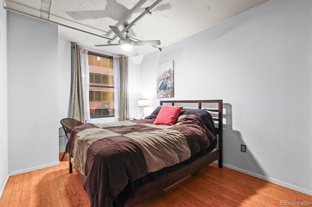 444 17th St Unit 603, Denver, CO 80202 - bedroom featuring baseboards, wood finished floors, and a ceiling fan