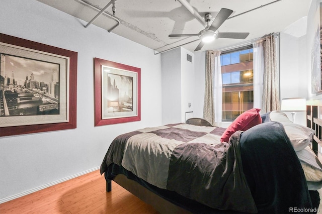 444 17th St Unit 603, Denver, CO 80202 - bedroom with baseboards, visible vents, wood finished floors, and ceiling fan