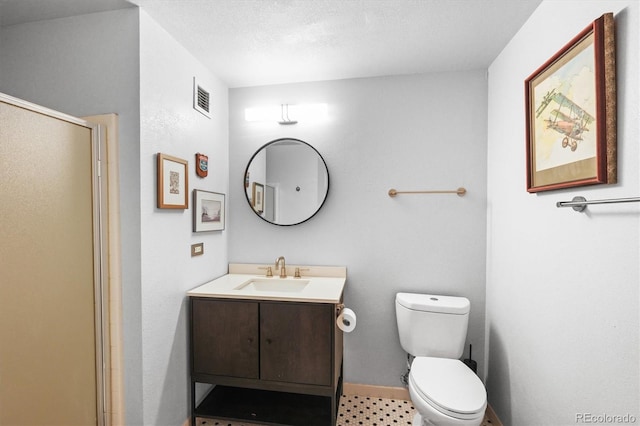 444 17th St Unit 603, Denver, CO 80202 - bathroom featuring toilet, vanity, an enclosed shower, baseboards, and visible vents