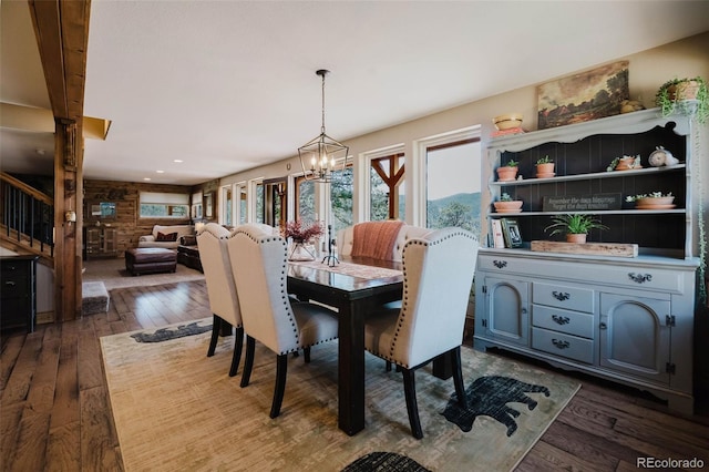 dining space featuring plenty of natural light, dark wood-type flooring, stairs, a chandelier, and recessed lighting