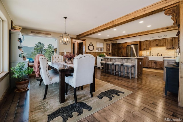 dining area with recessed lighting, a chandelier, dark wood finished floors, and beamed ceiling